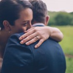 Couple hug with engagement ring in focus