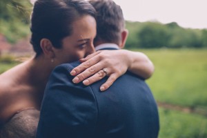 Couple hug with engagement ring in focus