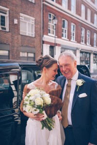 Bride and father of the bride by taxi