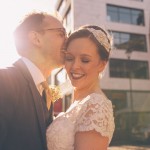 Bride and groom laughing with sunflare