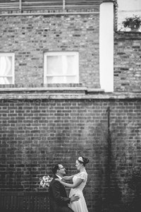 Bride and groom portrait brick wall