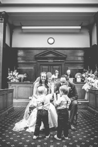 Bride and groom high-fiving children