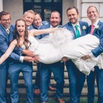 Groomsmen lifting up bride