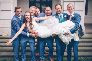 Groomsmen lifting up bride