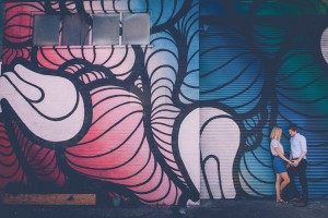 Couple against graffiti wall