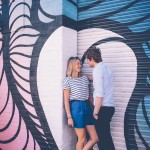Couple against graffiti wall