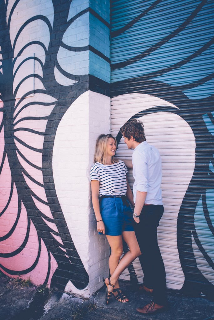 Couple against graffiti wall