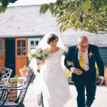 Bridesmaid and father walking to ceremony