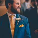 Groom waiting at front of aisle