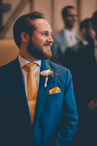Groom waiting at front of aisle