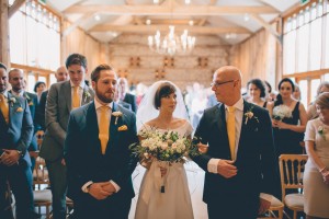 Bride, groom and father at alter