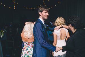 groom shaking hands with guest