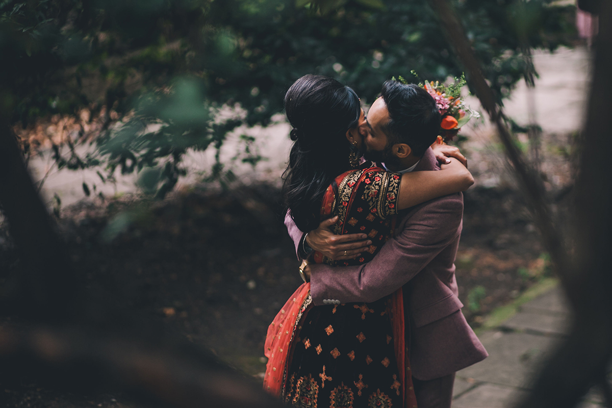 couple kissing indian wedding photography